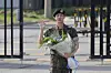 BTS's Jin, with a bouquet in his hand, waves at dozens of cameras on Wednesday as he gets discharged from the ROK Army 5th Infantry Division Recruit Training Center in Yeoncheon County, Gyeonggi, on Wednesday, after completing 18 months of his mandatory military service. [YONHAP]