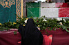 A woman mourns next to the flag-draped coffins of a group of security forces, who were killed during anti-government protests, during their funeral ceremony, in Tehran, Iran, on Jan. 14. [AP/YONHAP]