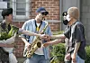 BTS's RM, center, plays 'Dynamite' on his saxophone for Jin on Wednesday. [NEWS1]