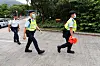 The police close the cordon line outside Shek Pik prison after a car with curtains drawn, one of two, was seen leaving the maximum-security facility just before sunrise in Hong Kong on April 29. Police at the scene confirmed that pro-democracy activist and former Hong Kong opposition lawmaker Gary Fan, who was imprisoned under Hong Kong's National Security Law, has left the prison, after finishing a prison sentence of four years and two months. [AFP/YONHAP]