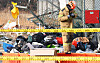 A firefighter is seen searching for remains and debris in the airplane crash site at Muan International Airport. [YONHAP]