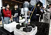 Visitors look at lithium-ion battery manufacturing processes at a booth during the Battery Korea 2024 conference on secondary battery materials, components, equipment and recycling at Coex in Gangnam District, southern Seoul, on Oct. 11, 2024. [NEWS1]