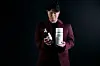 Rapper Choiza holds his bokbunja wine, Boonza, along with its packaging. [BOONZA]