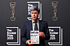 Author David Szalay poses with his book ″Flesh″ as he arrives for the Booker Prize 2025 ceremony at Old Billingsgate in London, Britain, on Nov. 10. [AP/YONHAP]