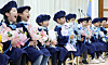 Children who completed the education curriculum at a kindergarten affiliated with the Geumjeong District Office in Busan hold flower bouquets and pose for a photograph at their graduation ceremony in the city in February. [NEWS1]