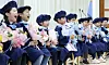 Children who completed the education curriculum at a kindergarten affiliated with the Geumjeong District Office in Busan hold flower bouquets and pose for a photograph at their graduation ceremony in the city in February. [NEWS1]