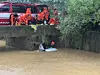 Firefighters work to rescue a driver trapped in a vehicle flooded with rainwater near a bridge in Gimpo, Gyeonggi, on Aug. 13. [YONHAP]