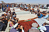Local residents pray over the bodies of victims of a Pakistani cross-border airstrike, including three local cricketers, during a funeral in the village of Khandaro in the Argun district of Afghanistan's eastern Paktika province on Oct. 18. [AP/YONHAP]