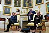 White House Press Secretary Karoline Leavitt, far right, looks at her smartphone in the Oval Office, as Katie Miller, wife of White House deputy chief of staff for policy Stephen Miller, listens during a press conference with U.S. President Donald Trump and Elon Musk, at the White House in Washington, D.C. on May 30. [REUTERS/YONHAP]