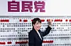 Japan's Prime Minister and President of the Liberal Democratic Party (LDP) Sanae Takaichi places a red paper rose on the name of an elected candidate at the LDP headquarters during the House of Representatives election in Tokyo on Feb. 8. [AFP/YONHAP]