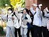 Students taking the College Scholastic Ability Test smile while holding their exam identification slips at a high school in Daegu on Wednesday, the day before the exam. [YONHAP]