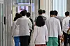 Medical professors at Seoul National University Hospital walk inside a hospital in downtown Seoul after finishing their professorial assembly on Thursday. [YONHAP]