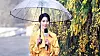 A scene from Netflix hit ″The Glory″ (2022-2023) shows its main antagonist Park Yeon-jin, played by Lim Ji-yeon, delivering the weather news in a rain coat. [SCREEN CAPTURE]