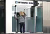 A delivery worker takes a peek at the closed doors of Optimus Asset Management's office in Gangnam, southern Seoul on October 13. [NEWS1]
