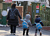 A caregiver and children are seen in front of a daycare center in Seoul on Feb. 11. [NEWS1]