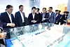 Attendees look at a bird's-eye view of the Hyosung Heavy Industries' high-voltage direct current (HVDC) transformer plant during a groundbreaking event at Hyosung Heavy Industries' Changwon facility in Changwon, South Gyeongsang, on July 30. From left, Democratic Party Rep. Huh Sung-moo, Hyosung Vice Chairman Lee Sang-woon, and Ministry of Trade, Industry and Energy Second Vice Minister Lee Ho-hyeon. [HYOSUNG GROUP]