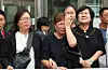 Families of victims who died in a fire that broke out at an Aricell battery plant shed tears as they speak to reporters after a court ruling at the Suwon District Court on Sept. 23 in Gyeonggi. [YONHAP]