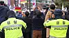 Two police officers stand in front of demonstrators protesting the impeachment of President Yoon Suk Yeol at a rally site in Jongno Distict in central Seoul last month. [YONHAP]