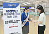 A passenger receives assistance from an Air Busan employee on navigating to the airline's new gates at Terminal 2 of Incheon International Airport [AIR BUSAN]