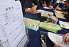 Job seekers fill out job application forms on Oct. 17, 2024, at Dasom Hall in Busan. [YONHAP]