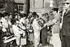KNRC employee Hwang Nahm-yong supervises the distribution of relief goods to refugees at an elementary school in Seoul on Nov. 2, 1950. [ICRC]