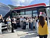 Single men and women are in line to draw lots to select their partners on the bus at a service area on their way to Naksan Temple on Friday morning. [LEE SOO-JUNG]
