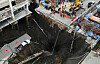 A vehicle teeters on the edge of a massive sinkhole that opened on Samsen Road near Vajira Hospital in Bangkok on Sept. 24. [REUTERS/YONHAP]