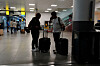 Travelers use a mobile phone at Terminal 8 at John F. Kennedy International Airport in New York on June 8, ahead of U.S. President Donald Trump’s reinstatement of a new travel ban barring citizens of 12 countries from entering the United States. [REUTERS/YONHAP]