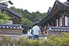 A man and woman participant stroll around the compound of Naksan Temple in Gangwon on Friday. [PARK SANG-MOON]