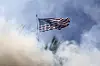 An American flag is viewed through smoke from flash-bang smoke grenades fired by federal agents as protesters and federal agents clashed near a Home Depot after a raid was conducted by Immigration and Customs Enforcement (ICE) in Paramount, California on June 7. [EPA/YONHAP]
