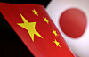 Printed Chinese and Japanese flags are seen in this illustration, made on July 21, 2022. [REUTERS/YONHAP]