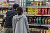 Shoppers inspect instant coffee mixes at a discount mart in southern Seoul on April 2. [YONHAP]