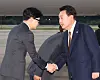 President Yoon Suk Yeol, right, is greeted by People Power Party Chairman Han Dong-hoon, left, as he arrives at Seoul Air Base in Seongnam, Gyeonggi, Sunday morning, ending a four-day official visit to the Czech Republic. [JOINT PRESS CORPS]