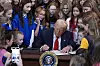 U.S. President Donald Trump signs an executive order barring transgender female athletes from competing in women's or girls' sporting events, in the East Room of the White House, in Washington on Feb. 5. [AP/YONHAP]