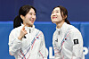 Short track speed skaters Kim Gil-li, left, and Choi Min-jeong talk during the medal ceremony for the women’s 3,000-meter relay at the Milan-Cortina 2026 Winter Olympics at the Milano Ice Skating Arena in Milan on Feb. 18. [KIM JONG-HO]