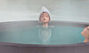 KPop Demon Hunters Rumi sinks into the bathhouse’s steaming waters. [SCREEN CAPTURE]