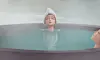KPop Demon Hunters Rumi sinks into the bathhouse’s steaming waters. [SCREEN CAPTURE]