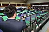 A National Election Commission official inspects a polling site at a middle school in Busan with a spy camera detector on Tuesday, a day ahead of the 2024 general election. [NEWS1]
