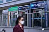 A pedestrian walks past ATMs for commercial banks in Seoul on June 3. [YONHAP]