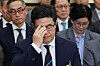 MBK Partners Chairman Michael ByungJu Kim adjusts his glasses as he appears at a National Assembly hearing in Yeouido, western Seoul, on Oct. 14, over the scandal surrounding Homeplus. [YONHAP]
