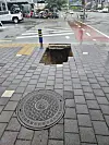 A sinkhole lies open on a sidewalk near a crosswalk in Dotong-dong in Namwon, North Jeolla, on June 21. [PARK]
