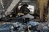 A displaced boy stands by a tent among the rubble of a destroyed building in the seaport area of western Gaza City, on May 21. Palestinian President Mahmoud Abbas on Wednesday called on the international community to take immediate action in response to the ″catastrophic and tragic″ situation in the Gaza Strip. [XINHUA/YONHAP]
