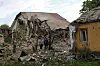 Resident Vadym Tsybenko, a 22-year-old, stands next to his house and a house of his neighbours, heavily damaged by a Russian drone strike, amid Russia's attack on Ukraine, outside of Kyiv, on May 18. [REUTERS/YONHAP]