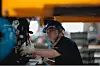 A laborer works on an assembly line during an organized press tour in the AVATR EV factory in Chongqing, China, May 20, 2025. AVATR Technology is a premium EV brand created through a joint venture led by Changan Automobile. [EPA/YONHAP]