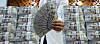 An official holds up dollar bills at Hana Bank's counterfeit response center in Jung District, central Seoul, on Dec. 17, 2025. [YONHAP]