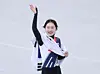 Short track speed skater Choi Min-jeong greets the crowd draped in the Korean flag after securing the silver medal in the women’s 1,500-meter final at the 2026 Milan-Cortina Winter Olympics at the Milano Ice Skating Arena, Italy, on Feb. 20 (local time). [NEWS1]