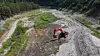 A Gangneung city official uses an excavator to channel water upstream of the Obong Reservoir, a key water source in Gangneung, Gangwon, on Aug. 31. [NEWS1]