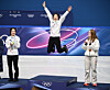 Kim Gil-li of Korea, center, jumps onto the podium after winning the gold medal in the women's 1,500-meter short track speed skating event at the Winter Olympics at Milano Ice Skating Arena in Milan on Feb. 20. Kim is flanked Choi Min-jeong of Korea, left, the silver medalist, and Corinne Stoddard of the United States, the bronze medal winner. [KIM JONG-HO]