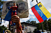 A government supporter holds an action figure of Super Bigote during a protest demanding the release of President Nicolas Maduro, who was captired by U.S. forces, in Caracas, Venezuela, Jan. 4. [AP/YONHAP]