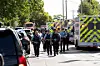 Law enforcement walk past a row of ambulances, after a shooting at Annunciation Church, which is also home to an elementary school, in Minneapolis, Minnesota, Aug. 27. [REUTERS/YONHAP]